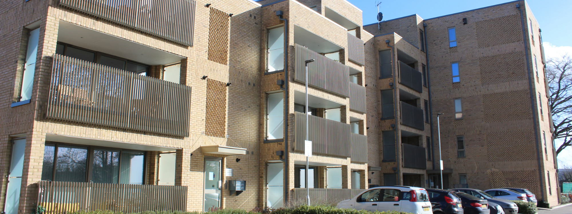 Front entrance and car park of La Riviere apartments